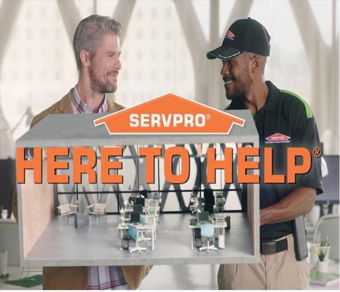 SERVPRO Logo with text, Here to Help, over image of client and technician holing a model of an office space