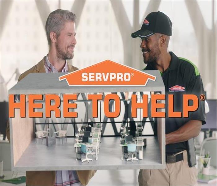 SERVPRO Logo with text, Here to Help, over image of client and technician holding a model of an office space