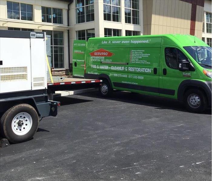 SERVPRO van and portable generator in front of commercial building